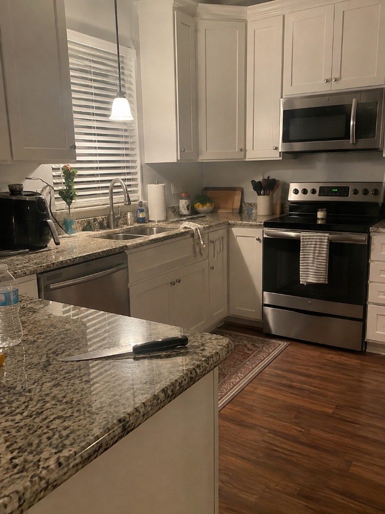 Example kitchen with an exposed knife on the island and a rug on the floor